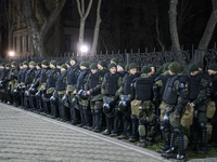Policemen stand guard ahead of a rally outside the Russian embassy to mark the Volunteer Day honouring fighters, who joined the Ukrainian ar...