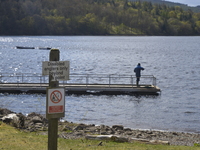 A sign advising the on-water platform is reserved for people with disabilities as a person engages in the sport and recrational activity of...