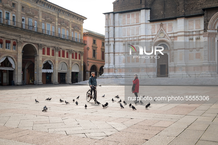 In an unusually empty Piazza Maggiore (the city's main square) on March 13th 2020, in Bologna (Italy) an encounter between a man and a woman...