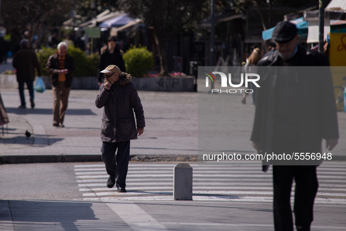 An elderly man walks in the center of the city of Trikala, after announcement of the Greek Organisation of Public Health for the citizens of...