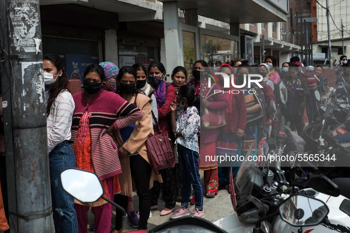 People stand in queue outside a medical store to buy face masks amid concerns about the spread of coronavirus, COVID-19 disease outbreak, in...