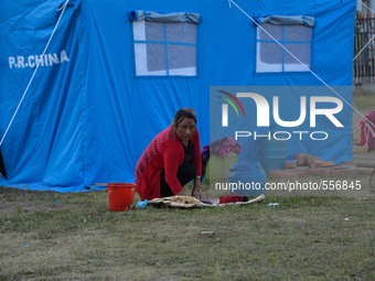 KATHMANDU, NEPAL - A woman wash her cloths at the earthquake victims camp in Kathmandu, May 1, 2015. (