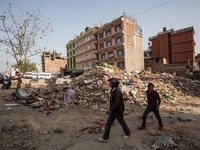Nepalese people are walking through the rubble of collapsed buildings on the Ring Road at the Balaju District of Kathmandu.
The death toll...