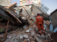Poland rescue team trying to look for human body inside the rubble caused by the collapse of a building behind the Ring Road at the Balaju D...