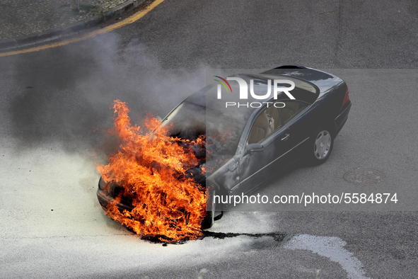 A car is consumed by the flames in Cascais, Portugal, on March 26, 2020. 