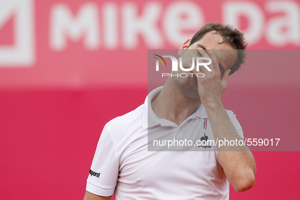 French tennis player Richard Gasquet reacts after losing a point during his Millennium Estoril Open ATP Singles semifinal tennis match with...