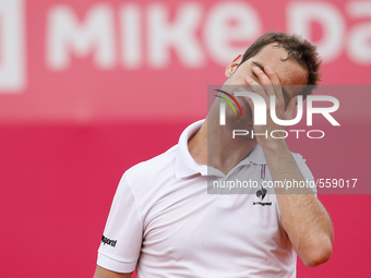French tennis player Richard Gasquet reacts after losing a point during his Millennium Estoril Open ATP Singles semifinal tennis match with...