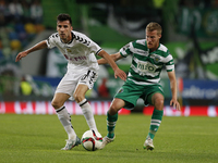 Nacional's midfielder Saleh Gomaa (L) vies for the ball with Sporting's midfielder Oriol Rosell (R)  during the Portuguese League  football...