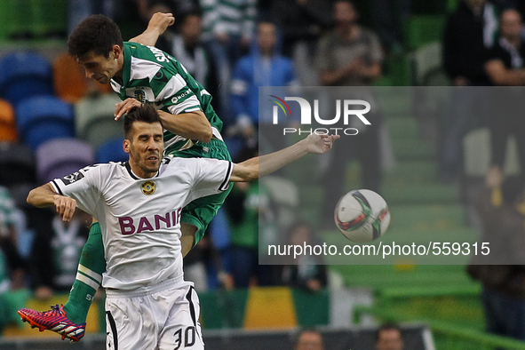 Nacional's midfielder Luis Aurelio (down) vies with Sporting's defender Cedric during the Portuguese League football match between Sporting...