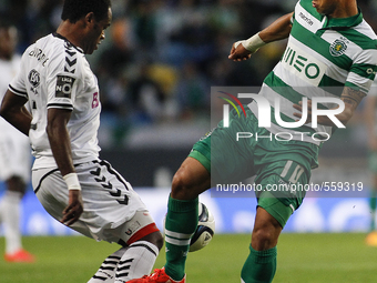Sporting's Colombian forward Fredy Montero (R) vies with Nacional's defender Zainadine Junior during the Portuguese League football match be...