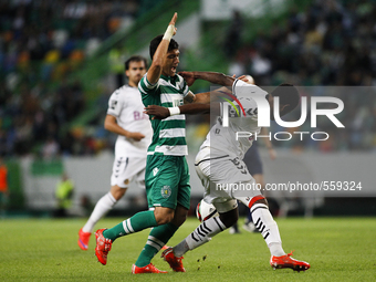 Sporting's Colombian forward Fredy Montero (L) vies with Nacional's defender Zainadine Junior during the Portuguese League football match be...