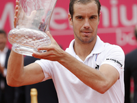 French tennis player Richard Gasquet lifts up his trophy during the award cerimony after winning the Portugal Open tennis tournament in Esto...