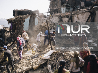 Survivors of the 2015 Nepal earthquake begin to search through the rubble of damaged buildings by hand, Tibukche Tol, Bhaktapur, Nepal. An e...