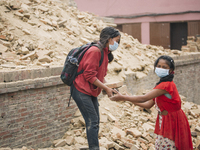 Children help with the salvage operation following the 2015 earthquake in Nepal., Patan Durbar Square, Patan (Lalitpur Sub-Metropolitan City...
