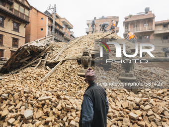 A Nepalese man surveys the damage to a temple at the UNESCO World Heritage site in Patan following the 2015 earthquake in Nepal., Patan Durb...