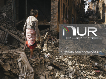 Survivors of the 2015 Nepal earthquake begin to search through the rubble of damaged buildings by hand, Tibukche Tol, Bhaktapur, Nepal. An e...