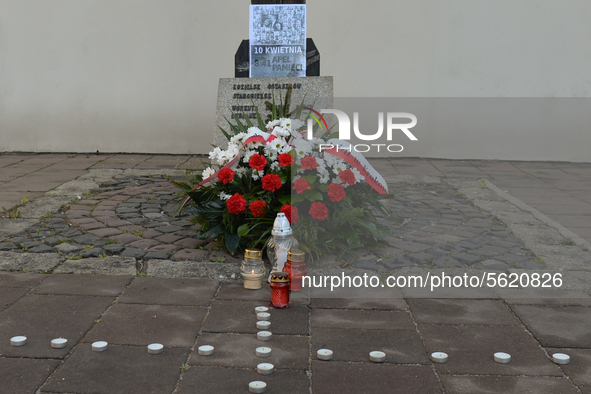 A view of the base of the Cross of Katyn with a poster showing photos of all passengers killed in the crash, seen on the day of the 10th ann...