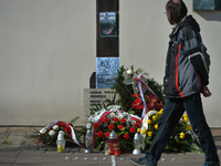 A man passes by The Cross of Katyn surrounded with flowers and wreaths, on the day of the 10th anniversary of Smolensk crash disaster.
In th...