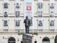 Late president Lech Kaczynski who died in a presidential plane crash in Russia statue in front of portraits other victims of the crash displ...