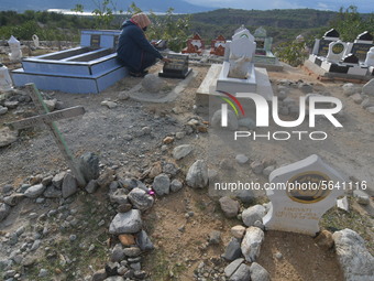 A number of Muslims remember and pray for their families who have died and are buried in the mass graves of victims of the earthquake, tsuna...