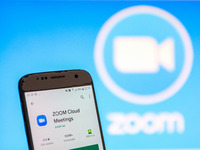 ZOOM Video Communications logo displayed on a phone screen, thumbnails of the application, smartphone and keyboard are seen in this multiple...