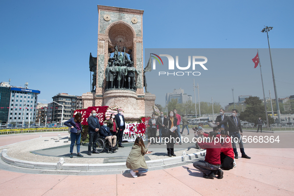 Syndicate members holding a wreath in order to lay it on the Taksim square Freedom monument for the May Day celebrations  on 1 May, 2020, in...