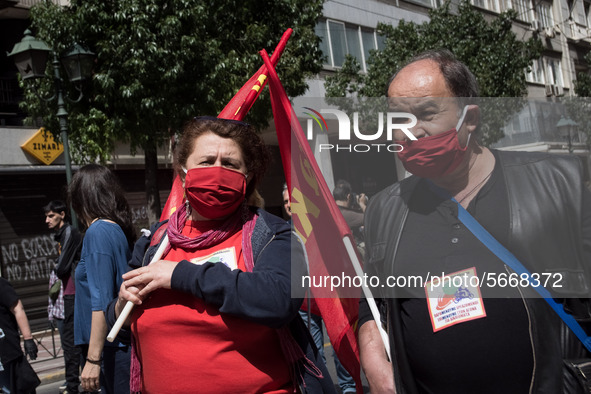 People wearing mask protest on International Worker's Day during the curfew due to Coronavirus (Covid-19) pandemic in Athens, Greece on May...