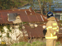 A firefighter care to rusted old house near forest burning site in Goseong, some 160 kilometers northeast of Seoul, on May 2, 2020. The fire...