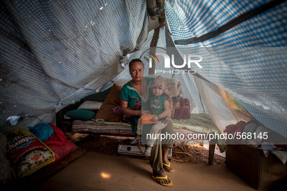 Sumit Roy Achami has taken shelter with her child in a tent. Dhading, Nepal. May 5, 2015 