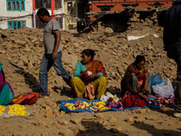 MAY 6, KATHMANDU, NEPAL - Street vendors waits for the customers at the debris of a destroyed temple in Durbar Square, a UNESCO world herita...