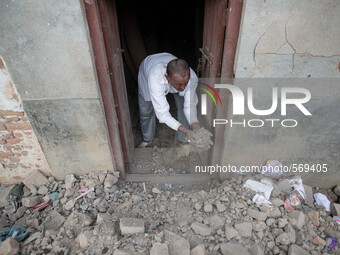 A man remove the rubbles front of his house in the Khokana Village, south of Kathmandu.
The death toll has risen to more than 7000 people an...