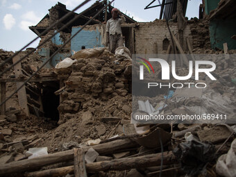 A man watch his collapsed house in the village of Khokana, south of Kathmandu, as he's removing the rubbles.
The death toll has risen to mor...