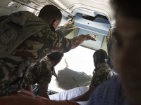 KATHAMNDU, NEPAL-- May 6, 2015--Nepalese Army officials air drop aid to earthquake-affected Sindhupalchok  region from an army plane  to are...