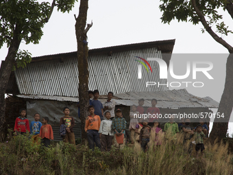 DHADING, NEPAL-- May 6, 2015--People gather to watch an Indian Air Force helicopter land in the village of Satyadevi in Dhading district of...