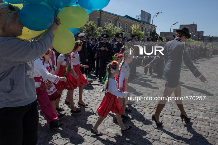 Police officers staring at the young girl, accompanying children's musical ensemble in national costumes.
On the eve of the May holidays in...