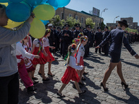 Police officers staring at the young girl, accompanying children's musical ensemble in national costumes.
On the eve of the May holidays in...
