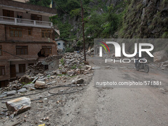A motorbike pass through a destroyed village on the Araniko Road near the Kobani Village (Tibetan Border).
Isolated Nepalese Villagers still...
