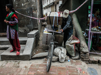 A man is crossing the daner mark with is street shop oods as he couldn't start his street shop due to earthquake at Katmandu, Nepal, 7 May 2...
