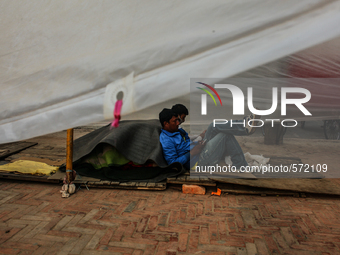 A man is spending lazy time at a temporary makeshift camp at Katmandu, Nepal, 7 May 2015. (