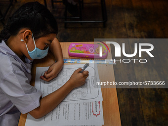 A elementary school student wears a face mask as a preventive measure in a class is a demonstration of learning amid the pandemic of the cor...