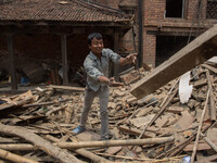 A man is throwing rubble in order to clean the area.
2 weeks after the powerful and deadly earthquake, a view of the oldest city in Nepal, B...