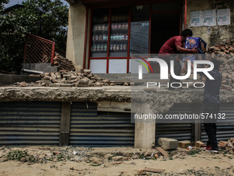 A man is loading goods after 14 days of earthquake at Swambhu, Kathmandu, Nepal, 8 May 2015. (