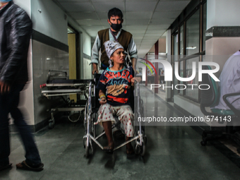 A man is taking her sister for treatment who is a victim of nepal earthquake at Bir Hospital, Kathmandu, Nepal, 8 May 2015. (