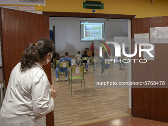 A teacher counts the students who attend the first voluntary review class for the university entrance exam, the EBAU in Norena, Spain, on Ju...