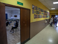 Students in a classroom in Norena, Spain, on June 8, 2020 wait for their teacher's instructions while in the hallway a teacher shows the cla...