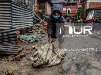 A boy is carrying bricks of his broken house at   Bhaktapur, Nepal, 09 May 2015. (