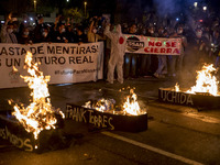 Nissan employees burn mock coffins while holding a banner reading ''Stop lies, we demand a real future'' during a protest against the closur...