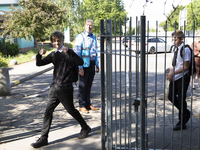  Year 10 pupils enter the gate. Ortu Gable Hall School in Corringham, Essex return after a long break due to the COVID-19 pandemic on Tuesd...