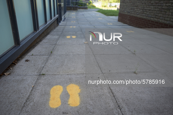  footprints on the ground to indicate where pupils should walk. Ortu Gable Hall School in Corringham, Essex return after a long break due t...