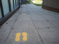   footprints on the ground to indicate where pupils should walk. Ortu Gable Hall School in Corringham, Essex return after a long break due t...